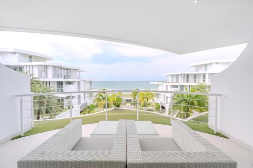 a view of the ocean from the balcony of a building at Pure Sunset Beach - Ocean View Room, Pattaya in Na Jomtien