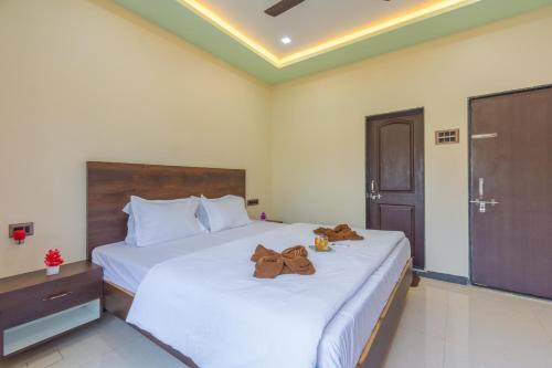 a bedroom with two beds with teddy bears on them at Aaru Retreat - Lonavala in Khamshet