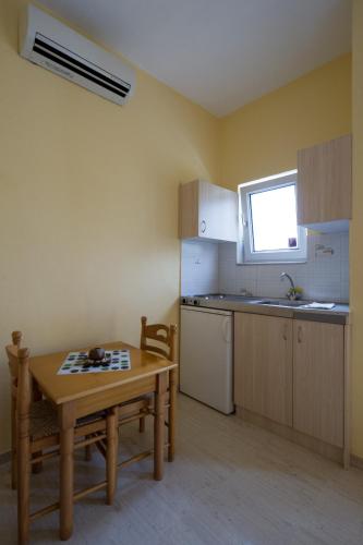 a kitchen with a table and a sink and a table and a table at Kanali Village Parga in Parga