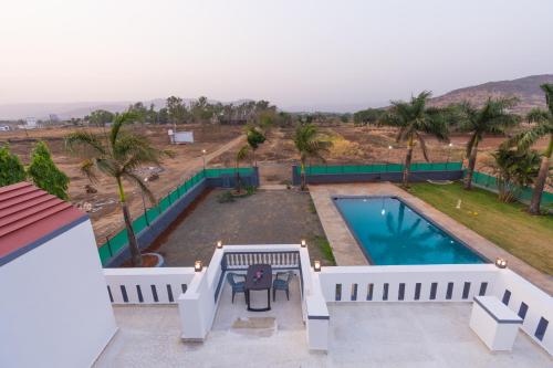 a view of a swimming pool from a house at Aaru Retreat - Lonavala in Khamshet
