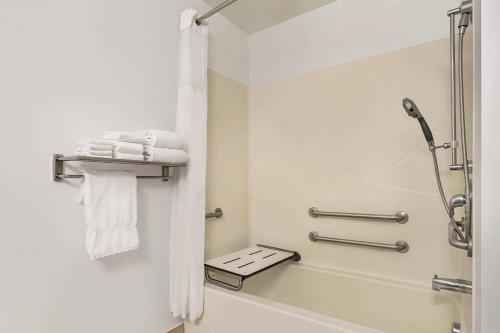 a bathroom with a shower and a bath tub with towels at Country Inn & Suites by Radisson, Boise West - Meridian in Meridian
