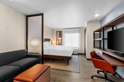 a hotel room with a bed and a desk at Everhome Suites Chandler Phoenix Fashion Center in Chandler