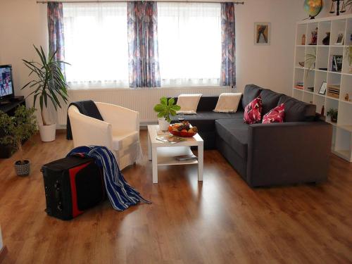 a living room with a couch and a table at Ferienwohnung Ambrosia in Bad Birnbach