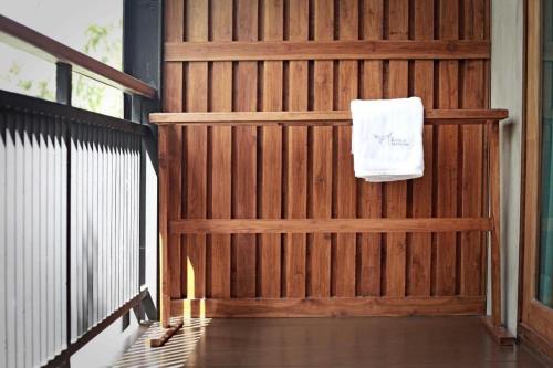 a wooden fence with a white towel hanging on it at The Buffalo Amphawa in Samut Songkhram