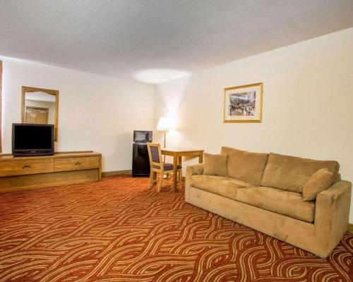 a living room with a couch and a table at Econo Lodge Inn & Suites in Stevens Point