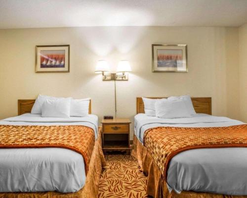 a hotel room with two beds in a room at Econo Lodge Inn & Suites in Stevens Point