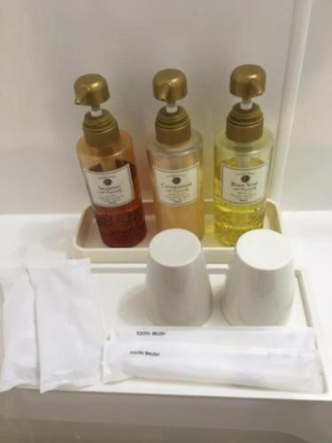 a refrigerator with three bottles of essential oils in it at Green Hill Hotel Urban in Kobe