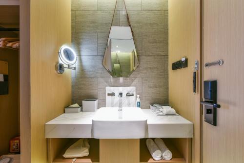 a bathroom with a white sink and a mirror at Atour Hotel Beijing Wangjing 798 Art District in Beijing
