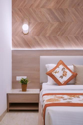 a bedroom with a bed and a wooden wall at Hotel Star Suites By Star Group in New Delhi