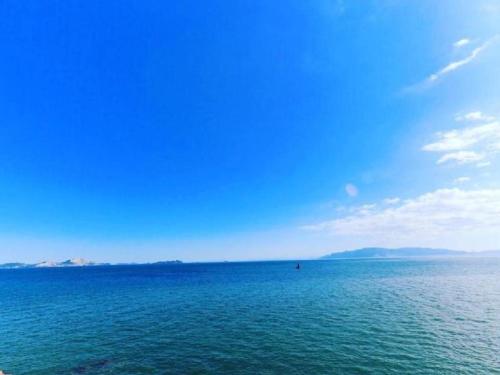 a large body of water with a blue sky at MISAKI TERRACE in Ako