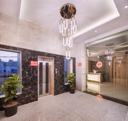 a lobby with a chandelier in a building at Hotel Star Suites By Star Group in New Delhi
