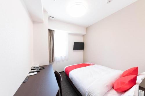 a hotel room with a bed and a desk at E Hotel Kumagaya Annex in Kumagaya