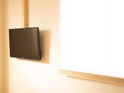 a flat screen tv hanging on a wall at NAMBA EBISU HOTEL in Osaka