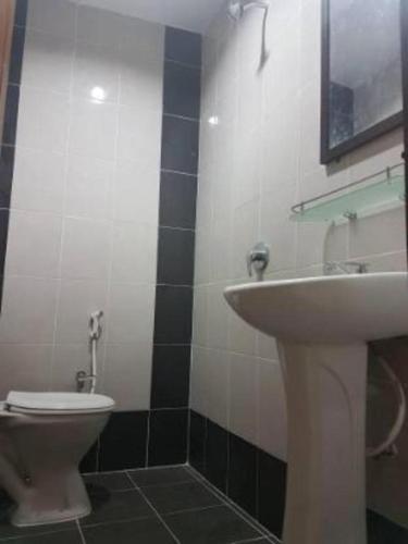 a bathroom with a sink and a toilet at Perhentian Tivoli Inn in Perhentian Island
