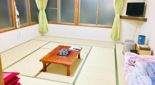 a living room with a coffee table in the floor at Hotel Alphastar Iwappara in Yuzawa