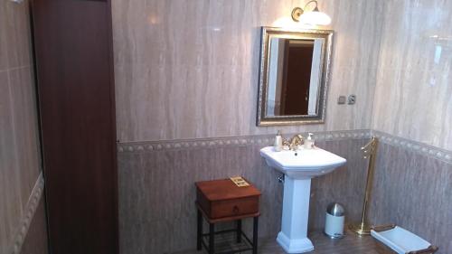 a bathroom with a sink and a mirror at Villa Podkowa in Podkowa Leśna