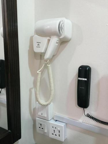 a white phone and a cell phone at Power Hotel in Georgetown