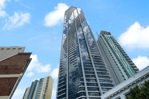 a tall glass building in a city with buildings at Indulgence at Meriton, Spectacular Views, Sleeps 6 Includes Carpark in Brisbane