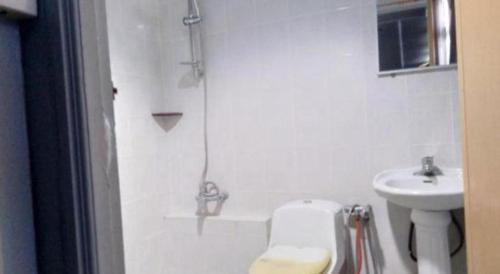 a bathroom with a shower and a toilet and a sink at OYO 90376 Centre Point Hotel in Limbang