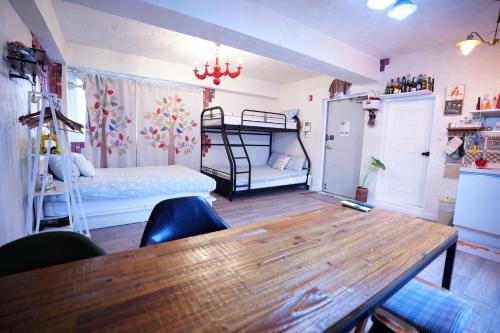 a room with a table and a bunk bed at Residence Unicorn in Seoul