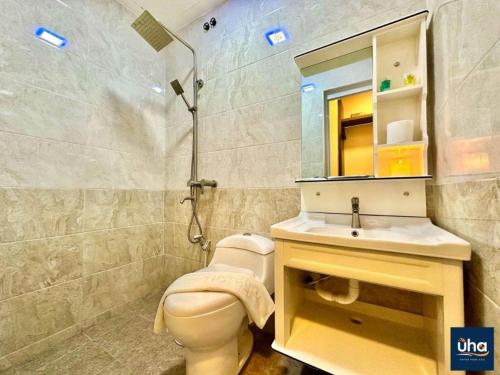 a bathroom with a toilet and a sink and a shower at Well Hotel by UHA in Johor Bahru
