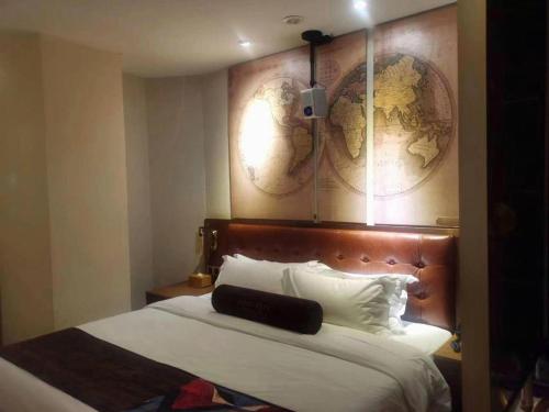 a hotel room with a bed with a map on the wall at James Joyce Coffetel·Shijiazhuang Economic and Technological Development Zone Chuangye Road in Shijiazhuang