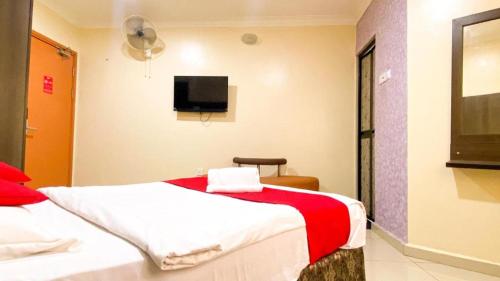 a hotel room with a bed and a flat screen tv at KK Inn Hotel Ampang in Kuala Lumpur