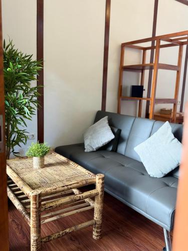 a living room with a blue couch and a table at 3WILL Bunaken Dive Resort in Bunaken