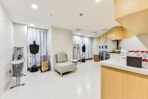 a large room with a kitchen with a chair at Atour Hotel Beijing West Railway Station South Square in Beijing