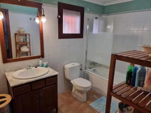a bathroom with a toilet and a sink and a tub at Calle Carlos Primero, Roda in Roda