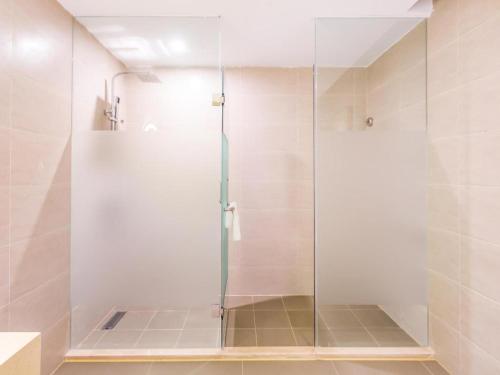 a shower with a glass door in a bathroom at Lavande Hotel Langfang Xianghe in Langfang