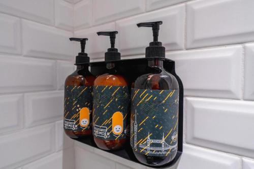 a rack of four bottles on a wall at City Comfort Premier Hotel Xiaogan Anlu Railway Station Dongda Times Square in Xiaogan