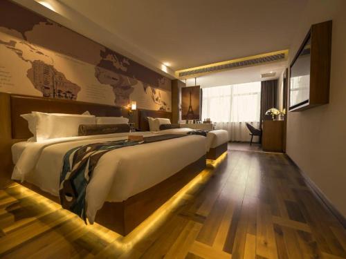a hotel room with two beds and a map on the wall at James Joyce Coffetel Shenyang North Railway Station Qishan Road Metro Station in Shenyang