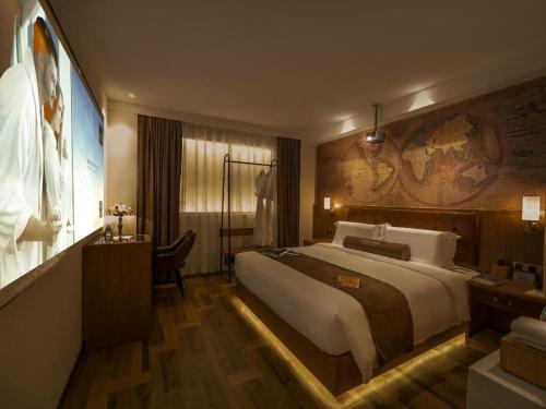 a hotel room with a large bed and a desk at James Joyce Coffetel Shenyang North Railway Station Qishan Road Metro Station in Shenyang
