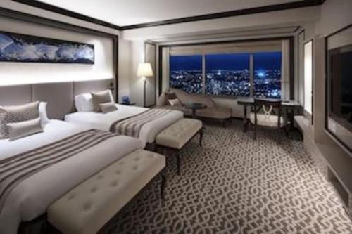 a hotel room with two beds and a large window at Yokohama Royal Park Hotel in Yokohama