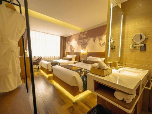 a hotel room with two beds and a sink at James Joyce Coffetel Shenyang North Railway Station Qishan Road Metro Station in Shenyang