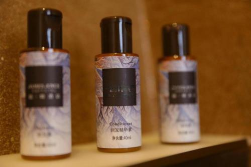 three bottles of hair products sitting on a shelf at James Joyce Coffetel Shenyang North Railway Station Qishan Road Metro Station in Shenyang
