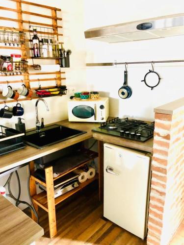a small kitchen with a sink and a microwave at Casa Torre San Lorenzo in Pisa