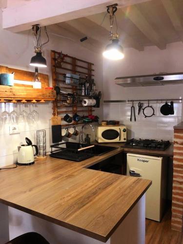 a kitchen with a large wooden counter top at Casa Torre San Lorenzo in Pisa