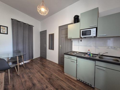 a kitchen with a sink and a table in a room at Mikra Homes24 in Gößnitz in Gößnitz