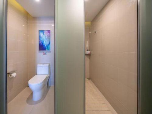 a bathroom with a toilet and a shower at Echarm Hotel Taizhou International Convention and Exhibition Center 