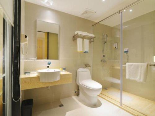 a bathroom with a toilet and a sink and a shower at City Comfort Inn Foshan Nanhai Avenue Guicheng Metro Station in Foshan