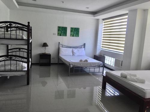 a bedroom with two bunk beds and a window at OYO 921 Sorrento Hotel And Resort in Vigan