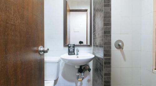 a bathroom with a sink and a toilet and a mirror at RedDoorz @ Express Inn Lapu Lapu in Gun-ob