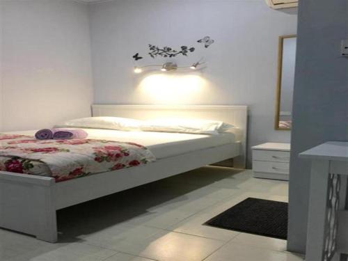 a bedroom with a bed with a light on the wall at The Second Room in Ranau