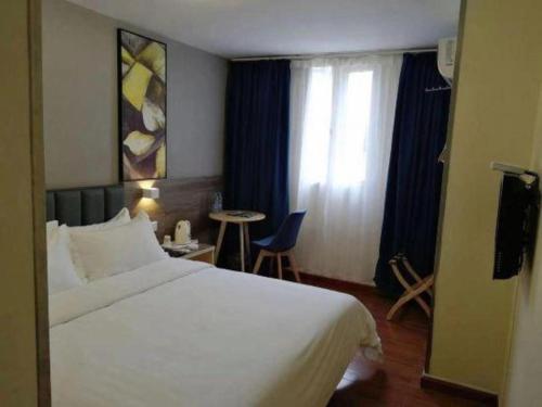 a hotel room with a bed and a table and a window at 7 Days Inn Changzhou Yancheng Technology Metro Station in Changzhou