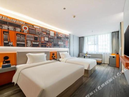 a hotel room with two beds and a tv at 7 Days Inn Baoding Railway Station in Baoding
