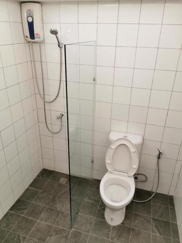 a bathroom with a toilet and a shower stall at The Regent Ubon in Ubon Ratchathani
