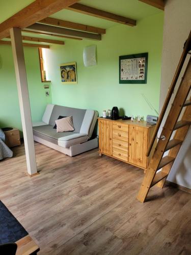 a living room with a couch and a wooden table at Apartamenty Na Poddaszu in Bierdzany