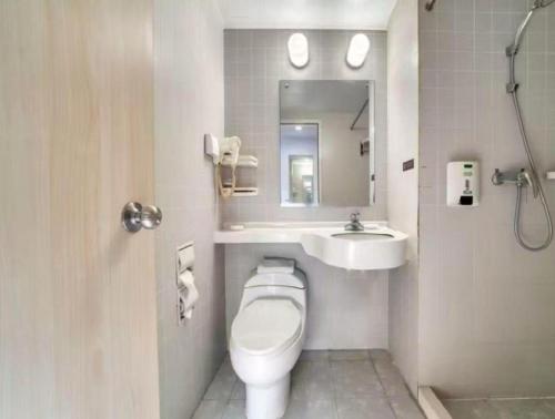 a bathroom with a toilet and a sink at Jinjiang Inn Zhenjiang Jiangsu University Suning Plaza in Zhenjiang